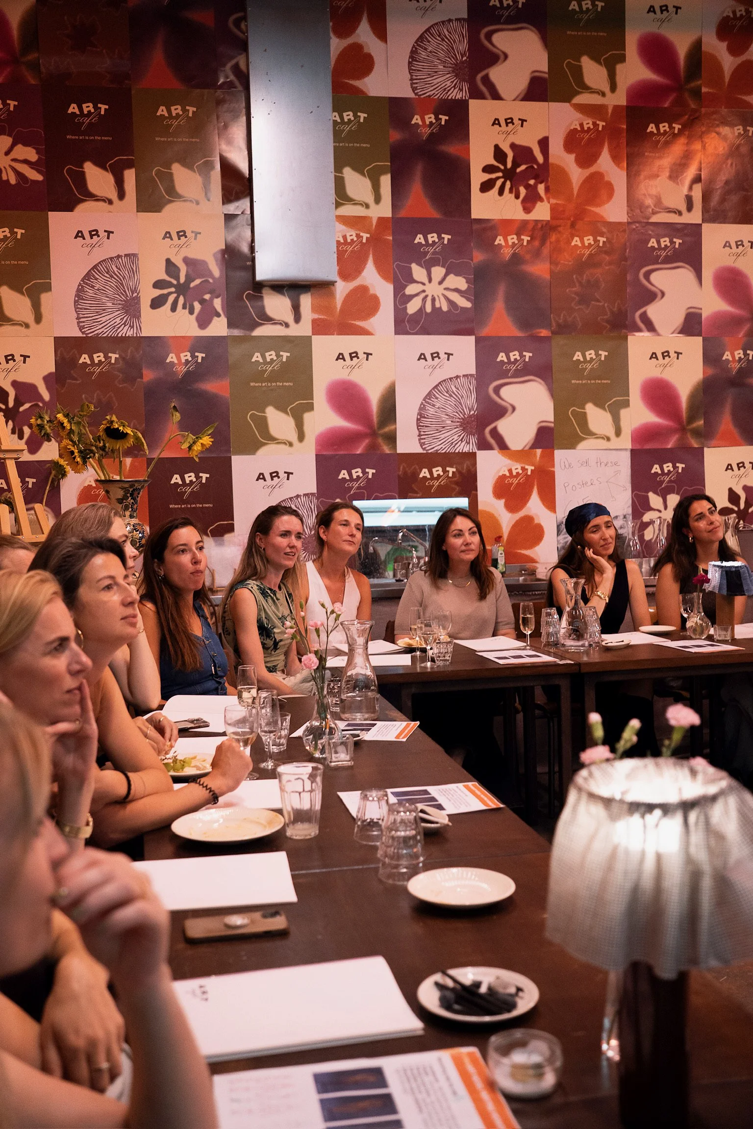 Group of friends gathered around a table for a creative bachelorette celebration at The Art Café in Amsterdam.
