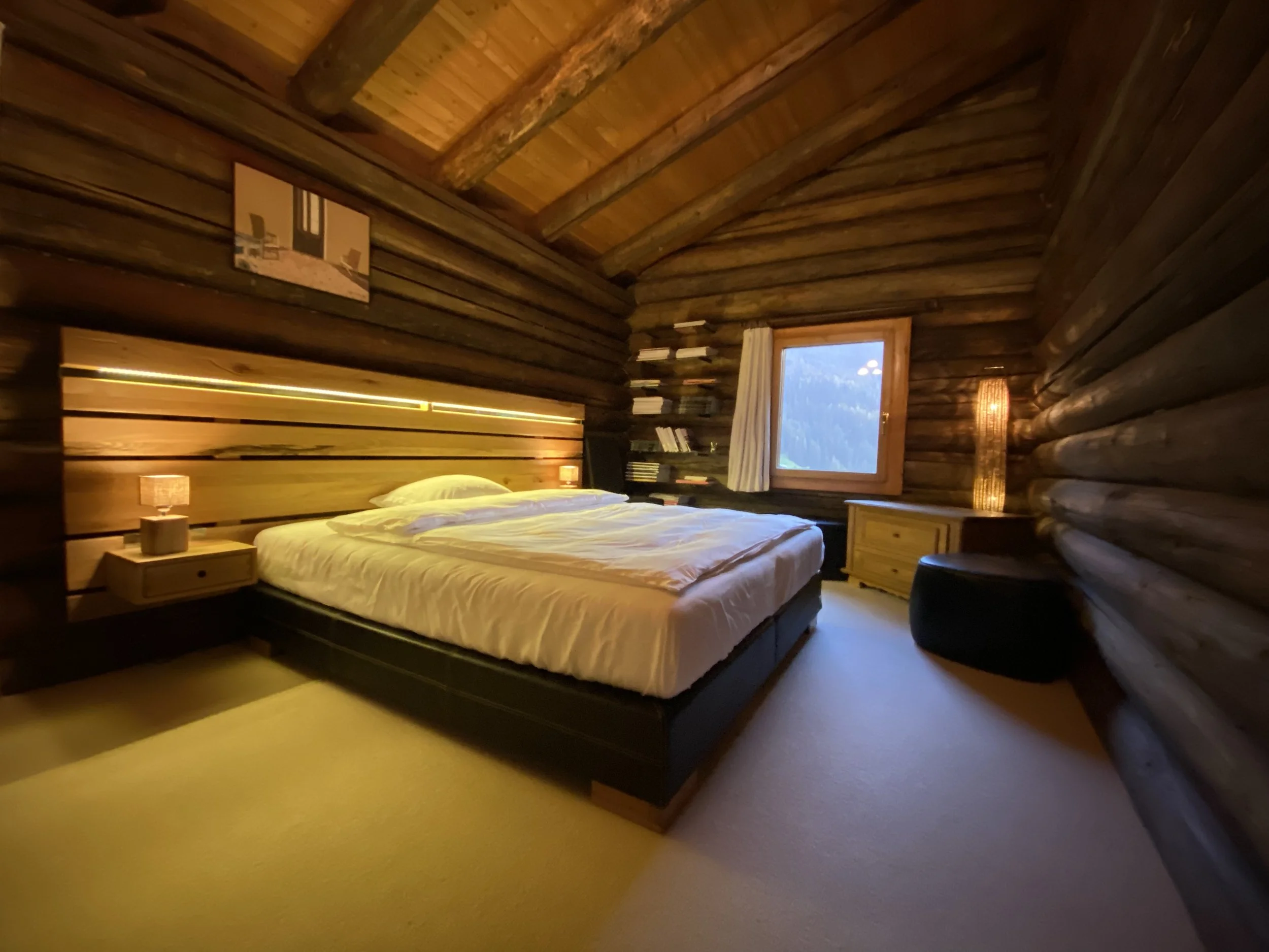 Serene Bedroom in Alpine Chalet: Full Wood Paneling, King Bed, Mountain View – Regenerative Sleep for WEF Politicians & Global Leaders Post-Forum in Swiss Luxury with Concierge. World Economic Forum Davos, Switzerland.