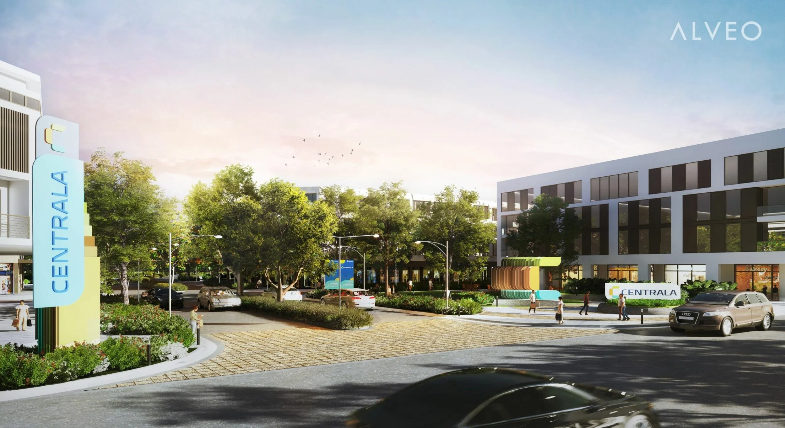 A modern outdoor scene at a commercial development called CENTRALA, with trees, parked cars, and people walking near a large white building with black windows, a colorful seating area, and a street with cars driving by.