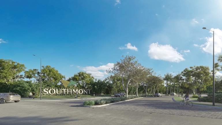 A scenic park entrance with a large sign that reads "Southmont," surrounded by trees, a paved pathway, parked cars, and a person riding a bicycle under a partly cloudy blue sky.