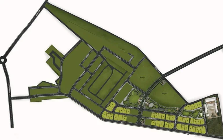 A detailed map of a planned residential community showing roads, green spaces, and lots, with some labeled areas and a large building or structure on the right side.