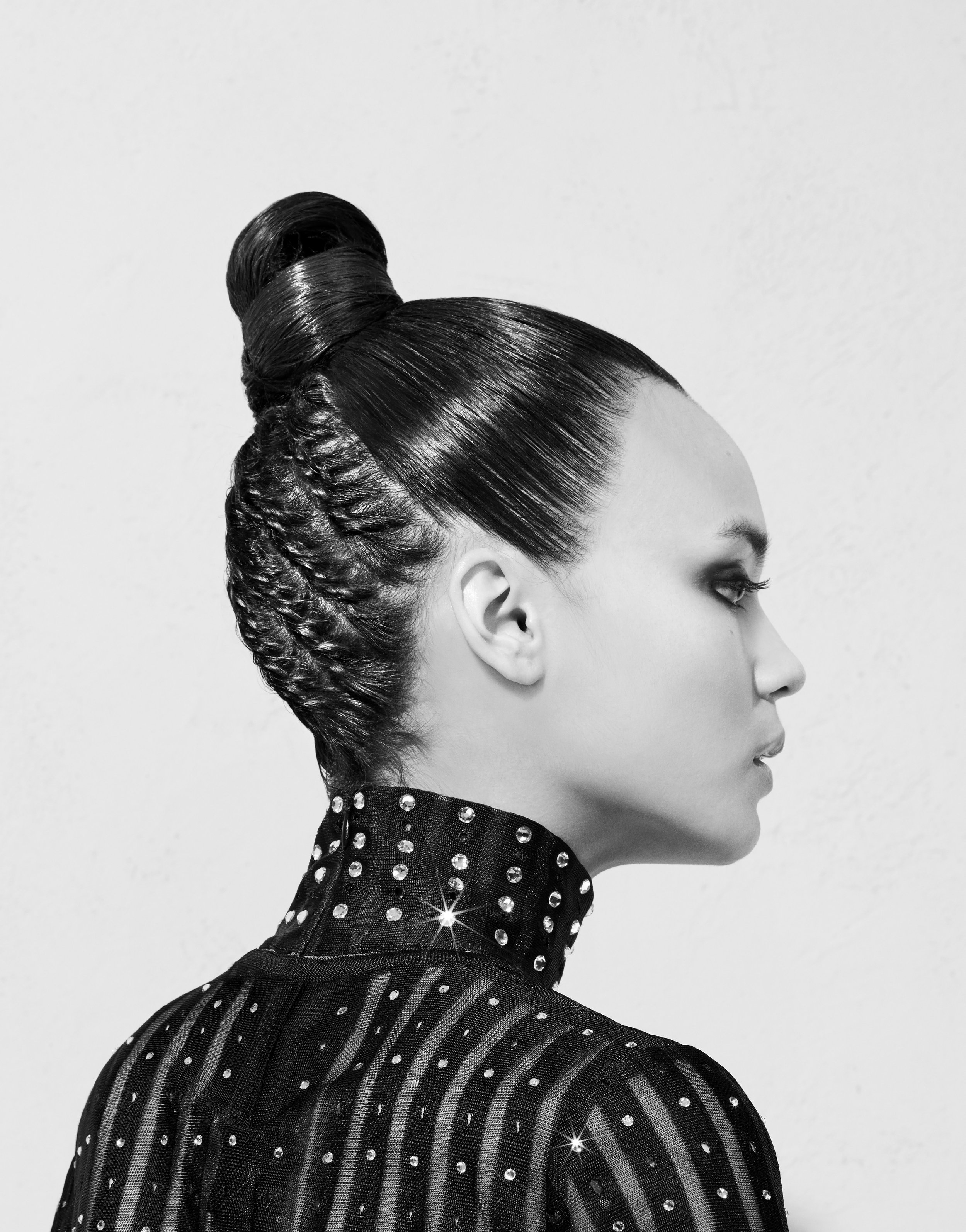 Black and white image of woman's hair in high bun