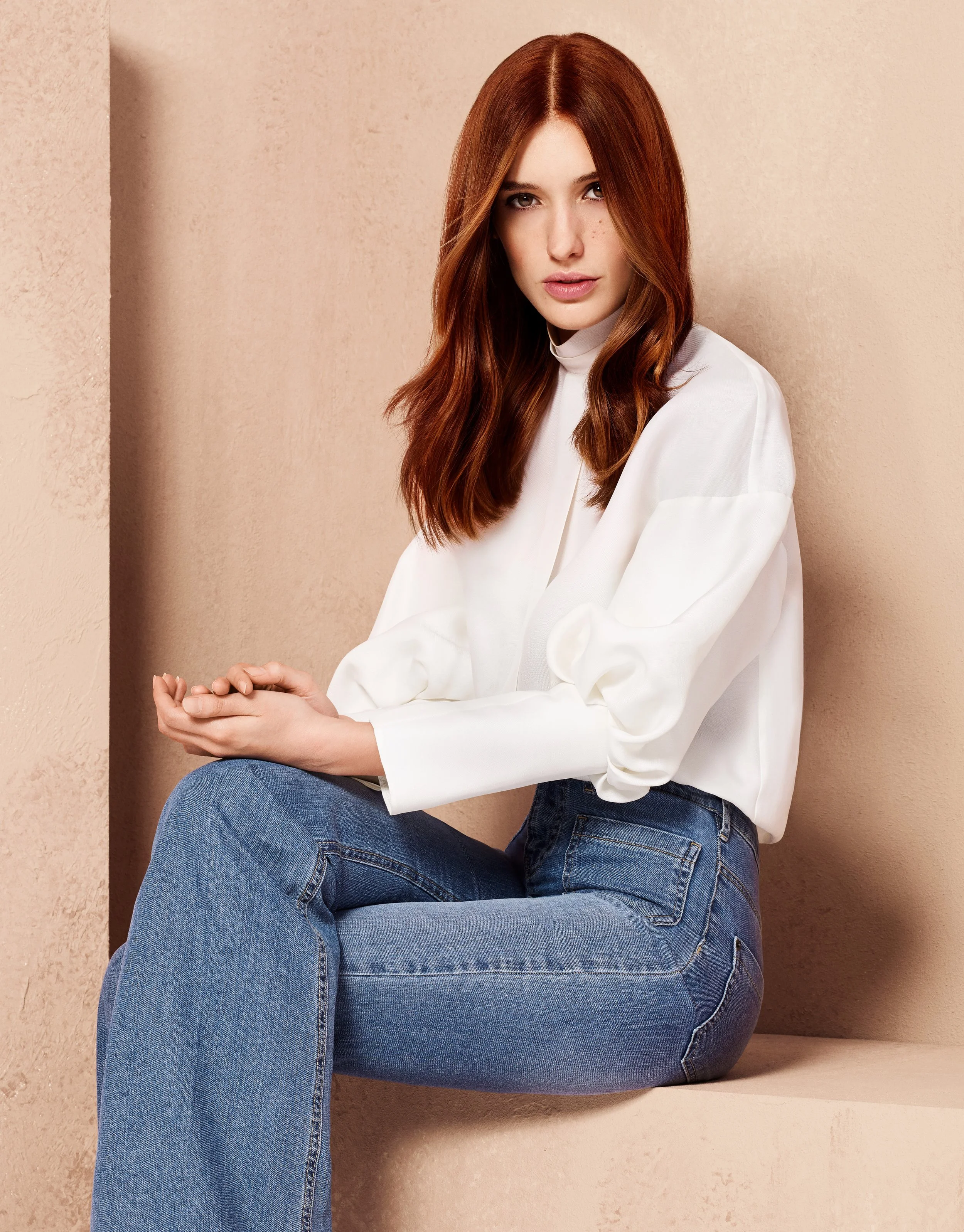 Woman posing sat down, ginger/red hair