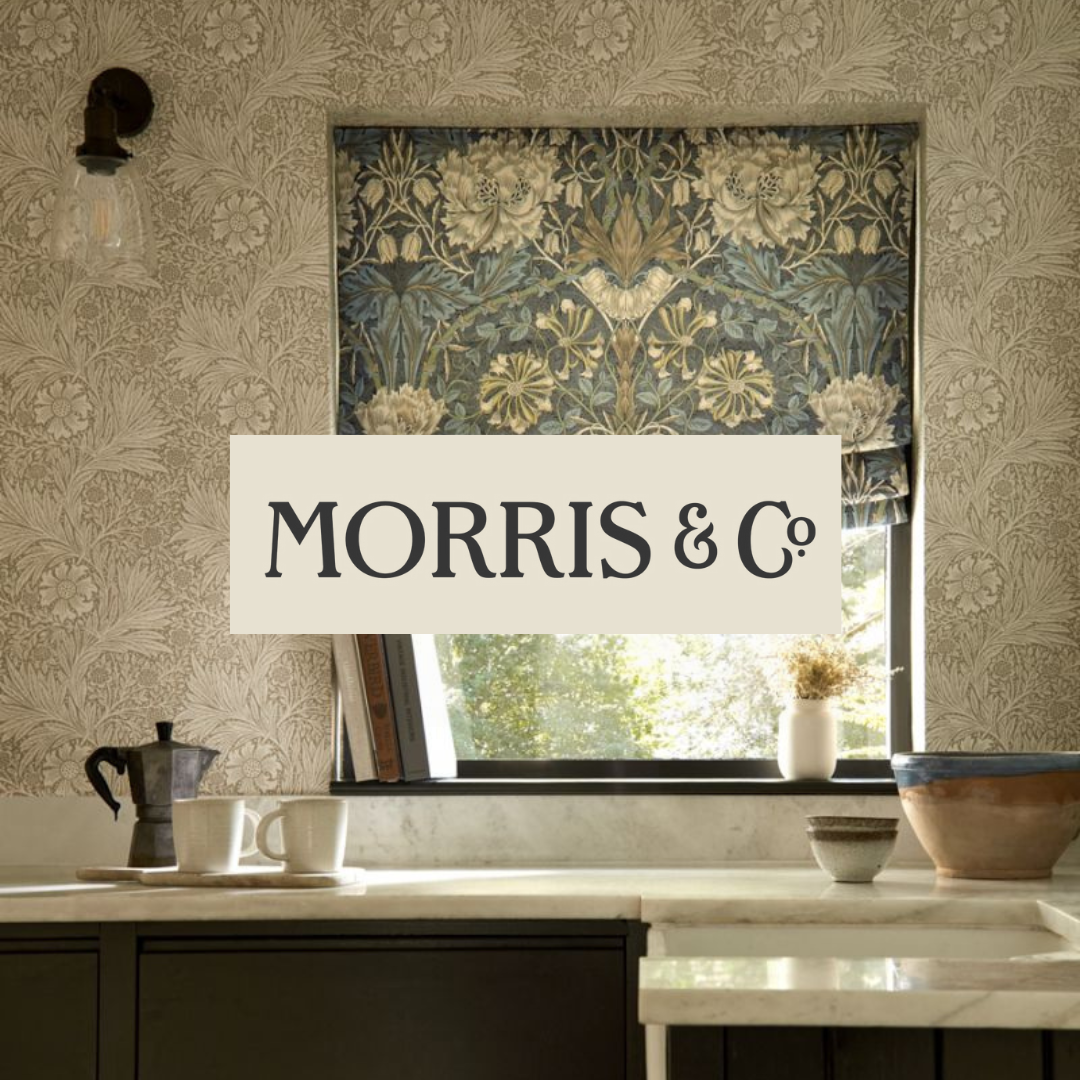 Interior a kitchen with a window, floral wallpaper, and kitchenware on the counter, featuring a lamp, cups, and bowls.