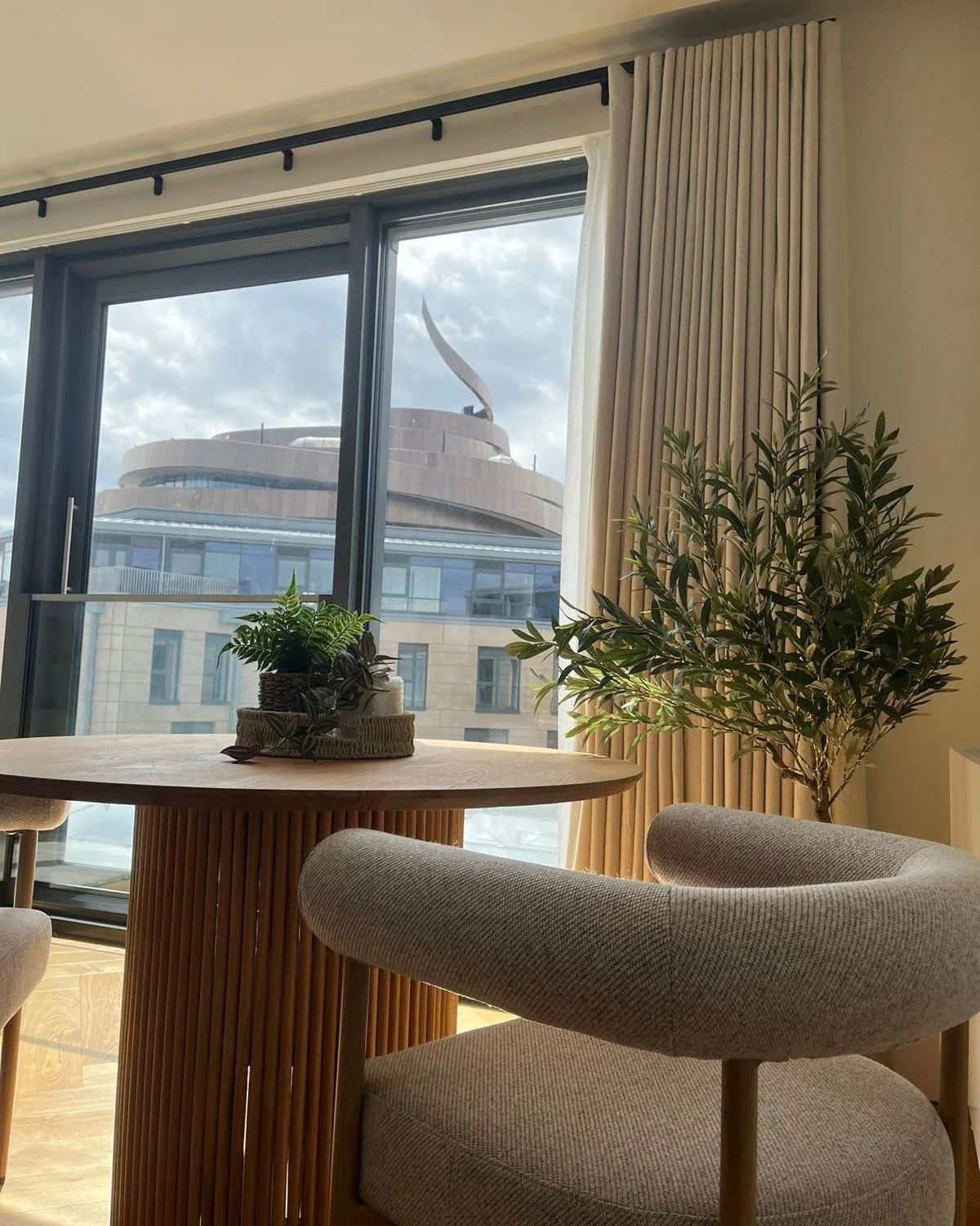 Beautiful boucle chair in front of beautiful curtains with W Edinburgh in the background 
