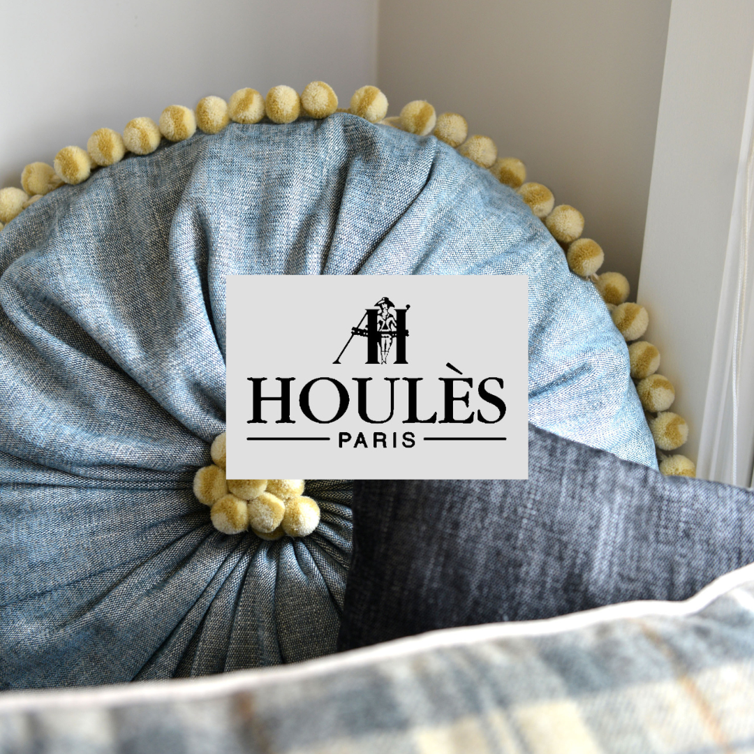 Decorative throw pillows with a logo of Houles Paris in the center, featuring a stylized figure and the brand name.