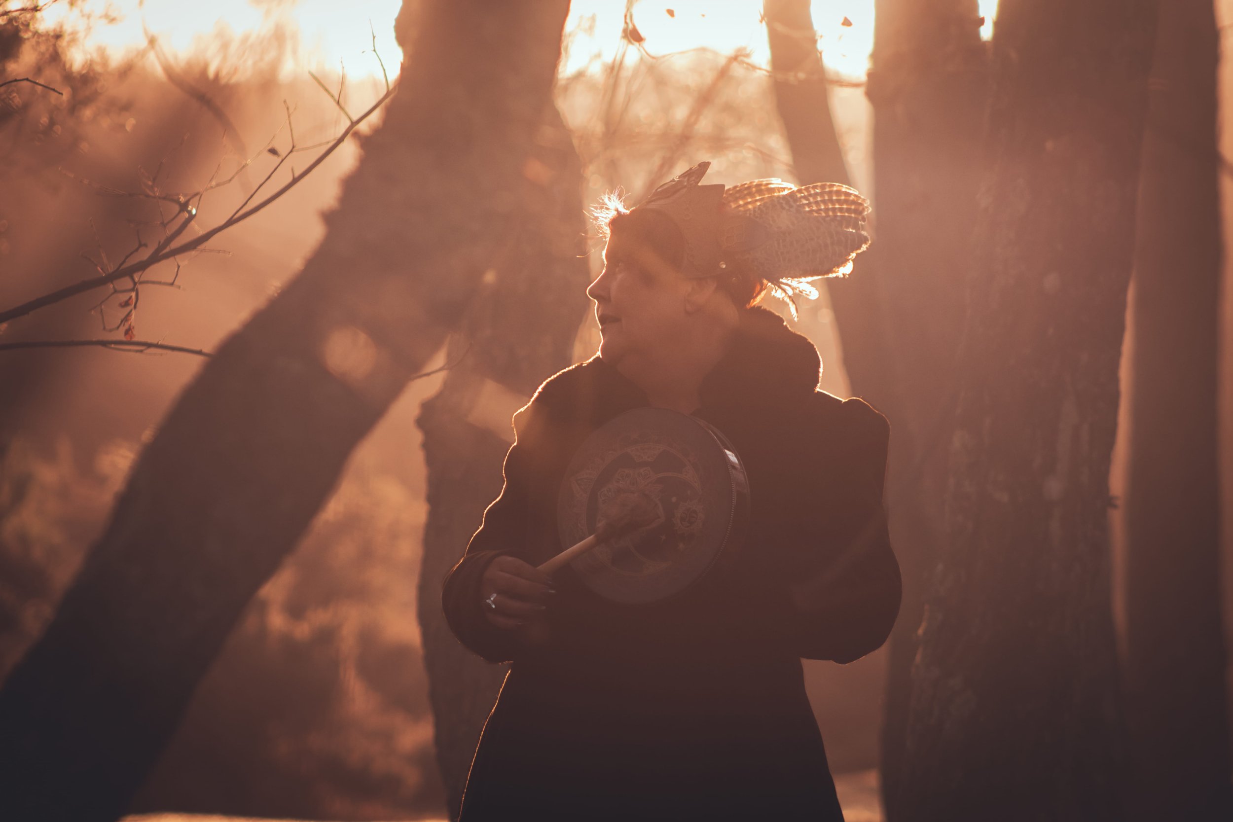 SAXON SU IN Ceremonial crown silhouette at sunrise during seasonal ritual in Hampshire woodland