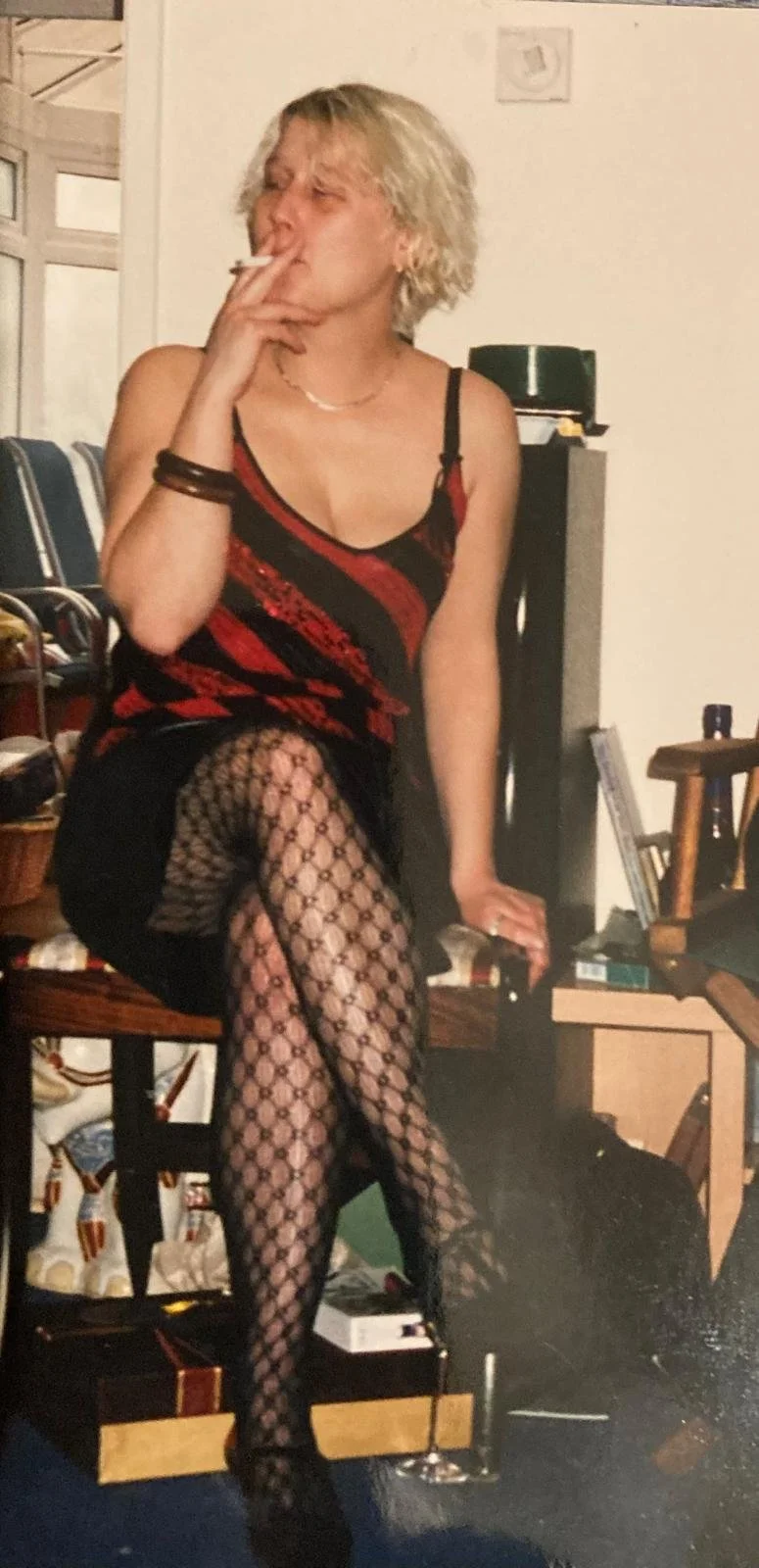 Su as a rebellious teenager in the 80's, fishnet stockings and smoking a cigarette
