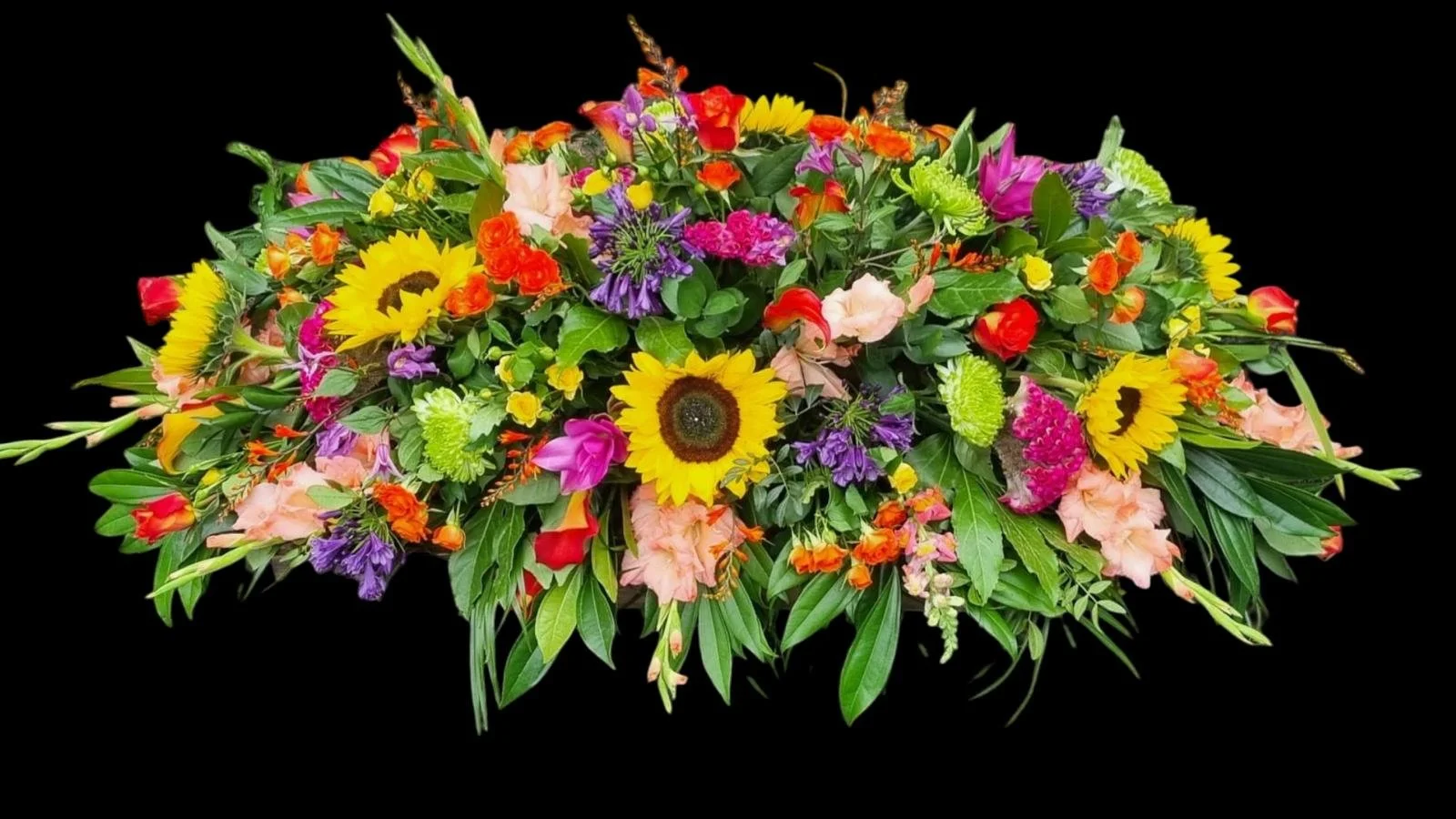 Colorful floral arrangement with sunflowers, roses, lilies, and other flowers against a black background.
