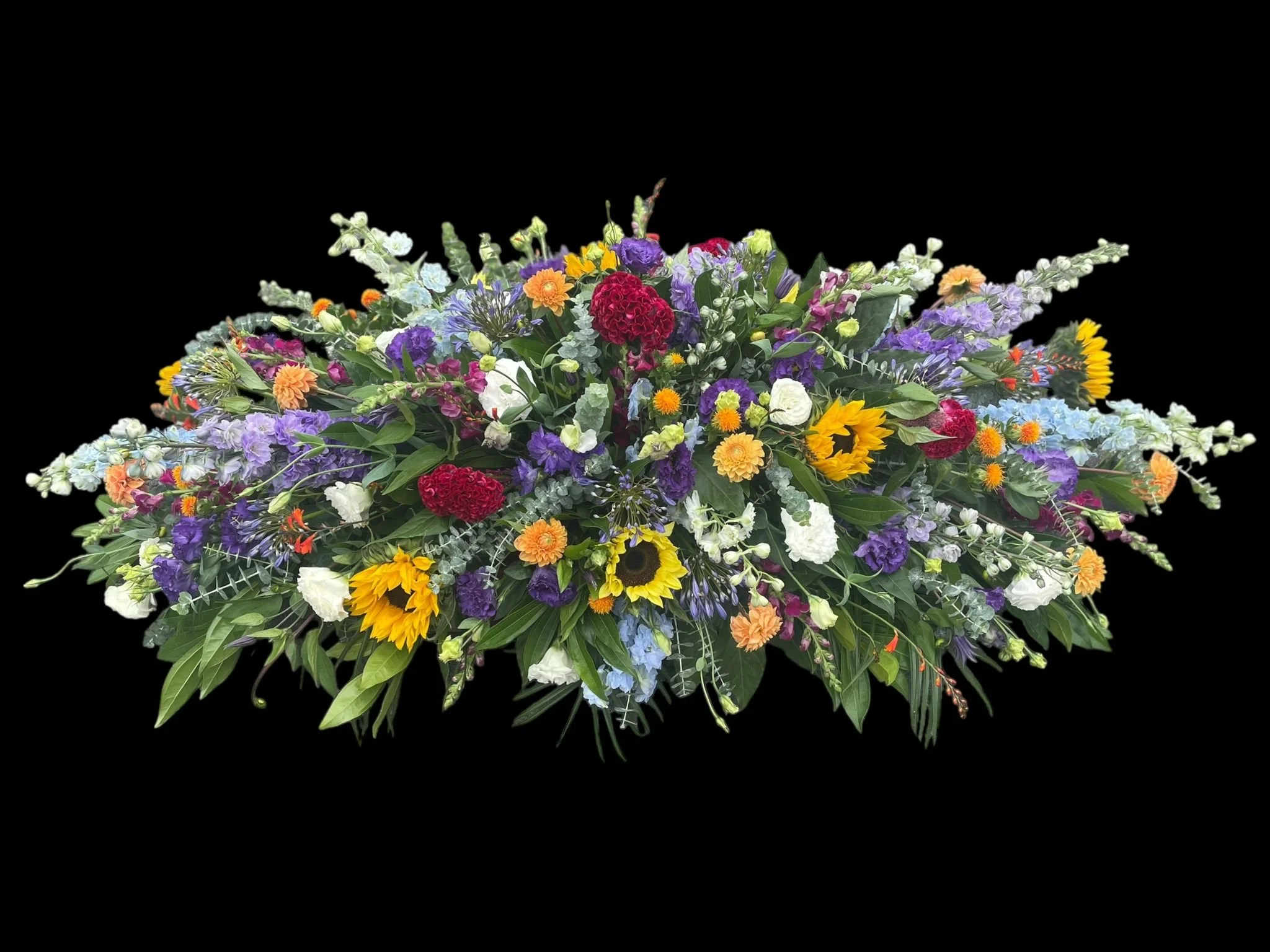 Colorful flower arrangement with various types of flowers including sunflowers, roses, daisies, and other wildflowers against a black background.