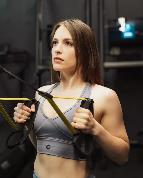 A woman working out with a resistance band in a gym