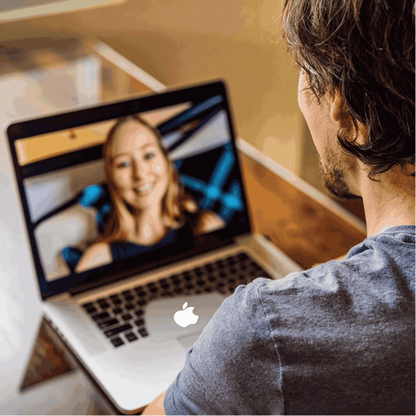  Professional on a video call at a laptop in a modern office