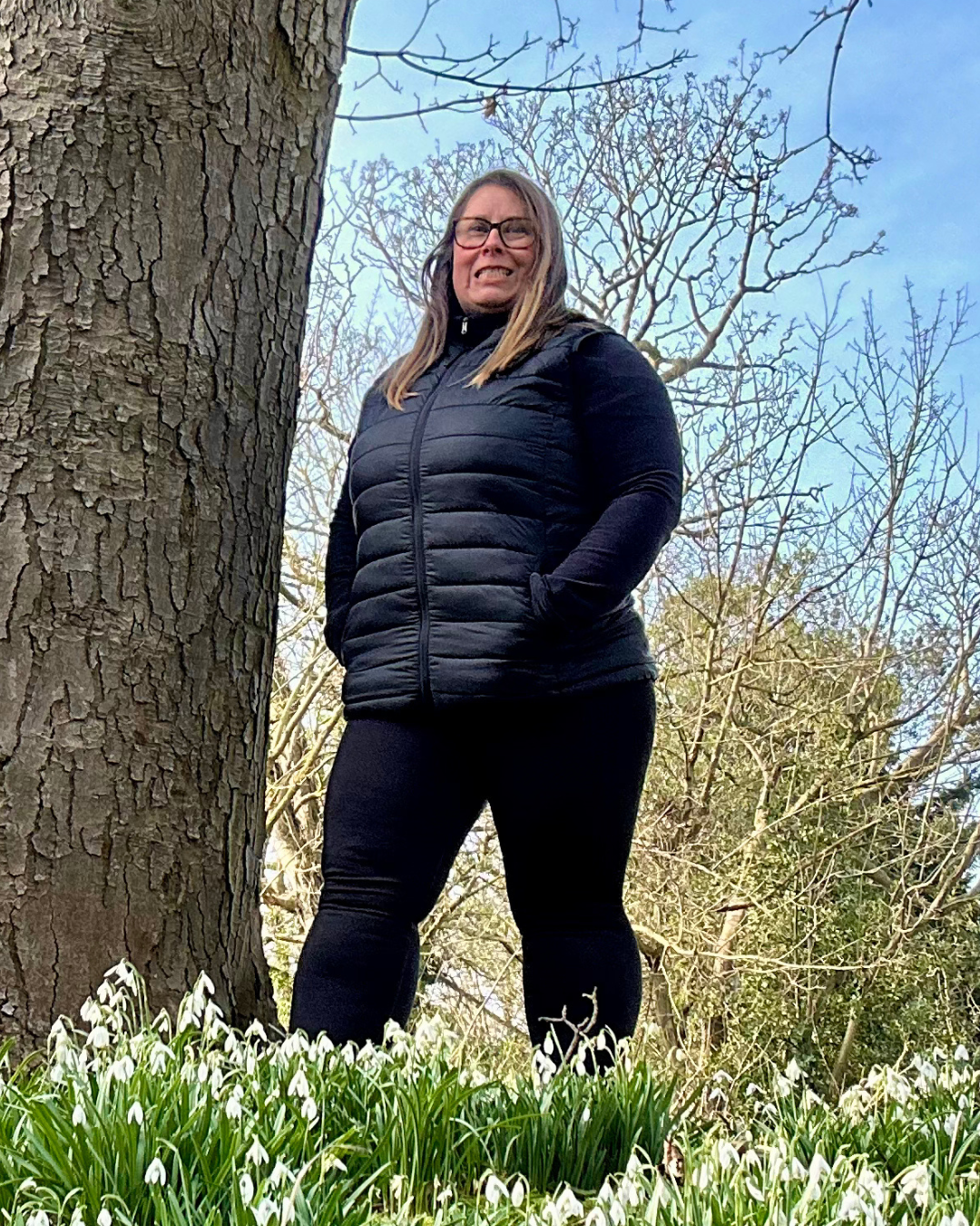 Lesley standing confidently outdoors against a tree - Worcester menopause coach helping midlife women rediscover themselves and feel unstuck
