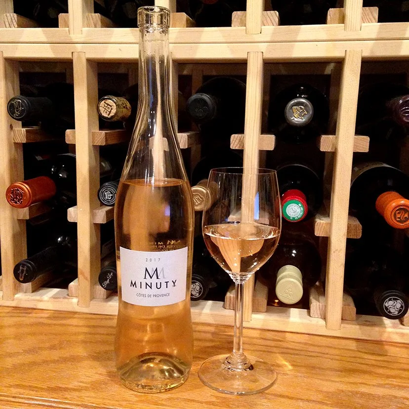 a bottle of M de Minuty Côtes de Provence in a wine celler