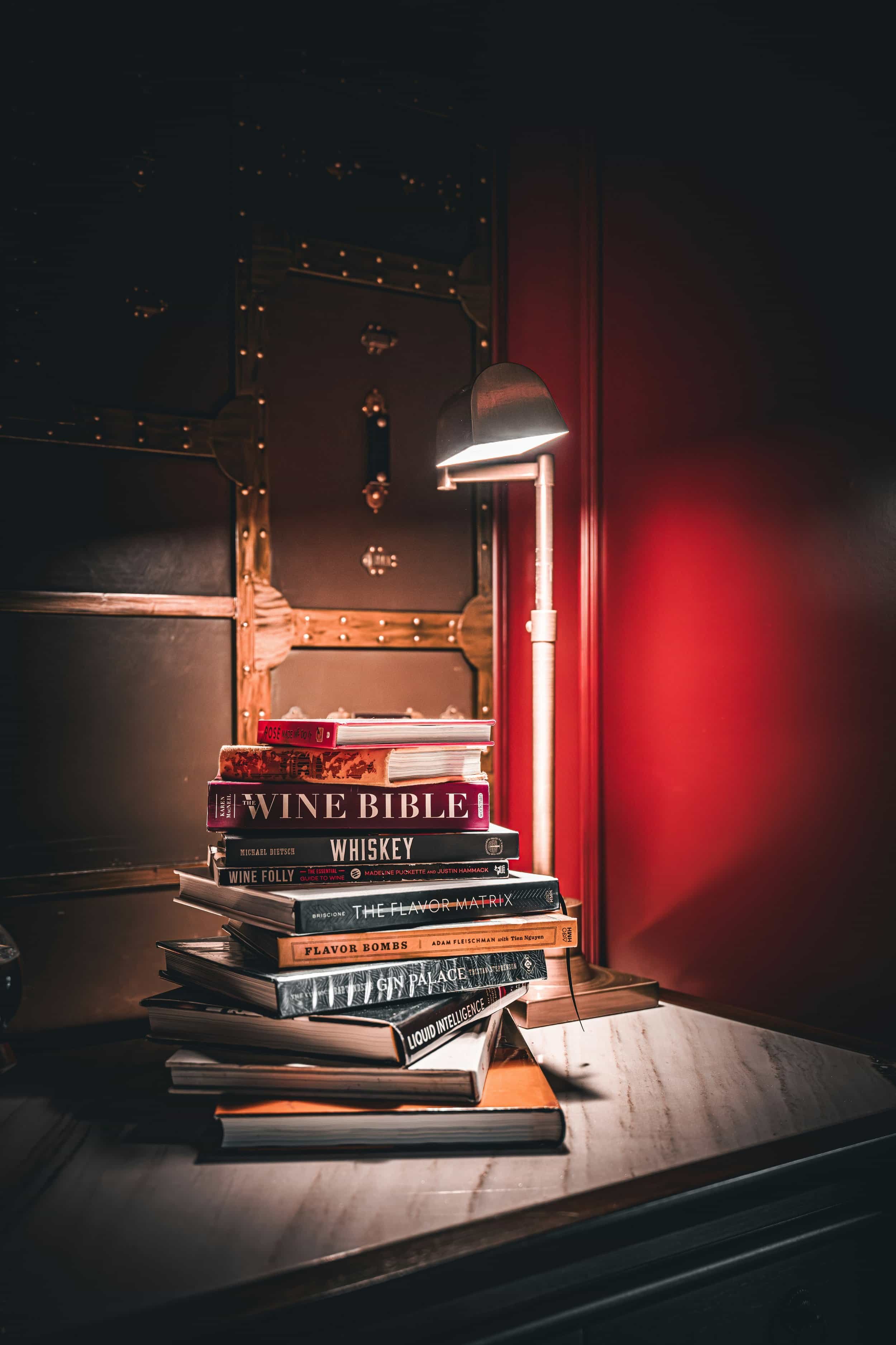 A stack of wine books, such as a wine bible and wine tips