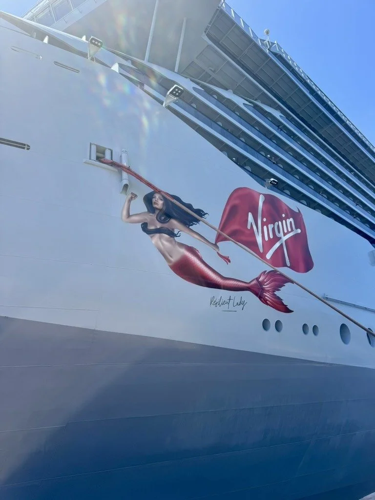 Mermaid artwork and Virgin flag on the bow of Virgin Voyages Resilient Lady