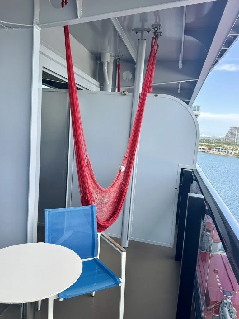 Red hammock on a RockStar suite balcony on Resilient Lady, docked in Miami