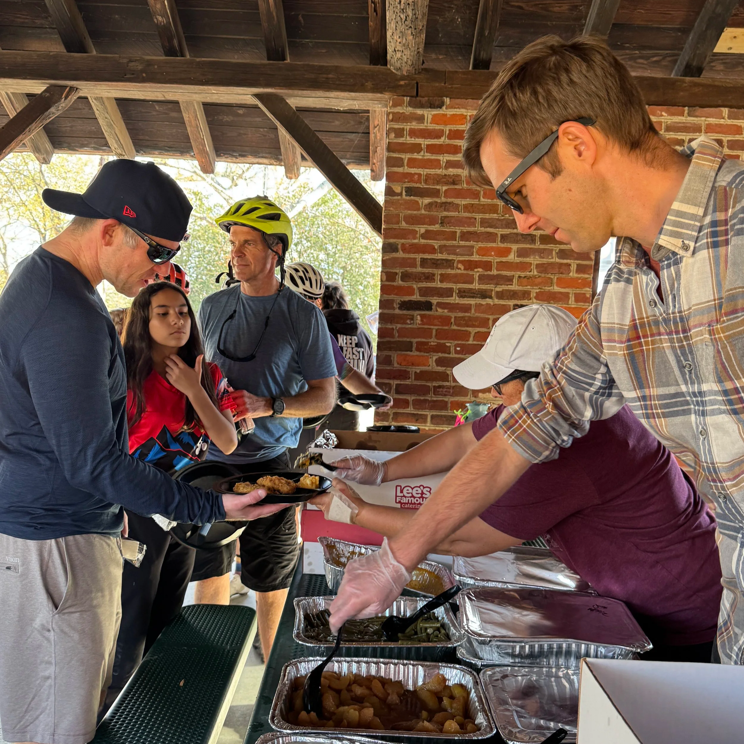 volunteers serving food to participants