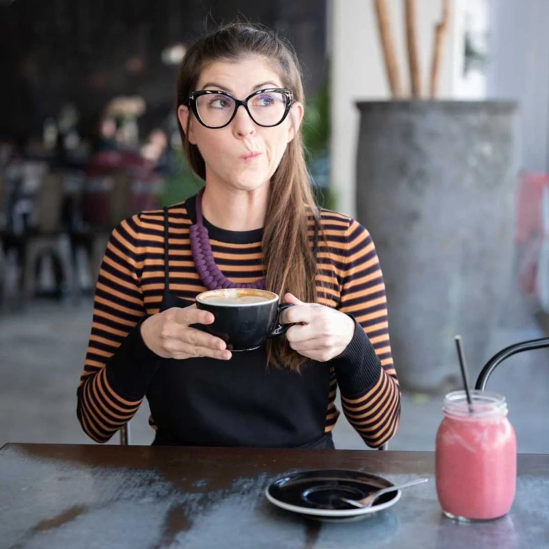 Portrait of Meli holding coffee in Paris café, Locals & Travellers founder