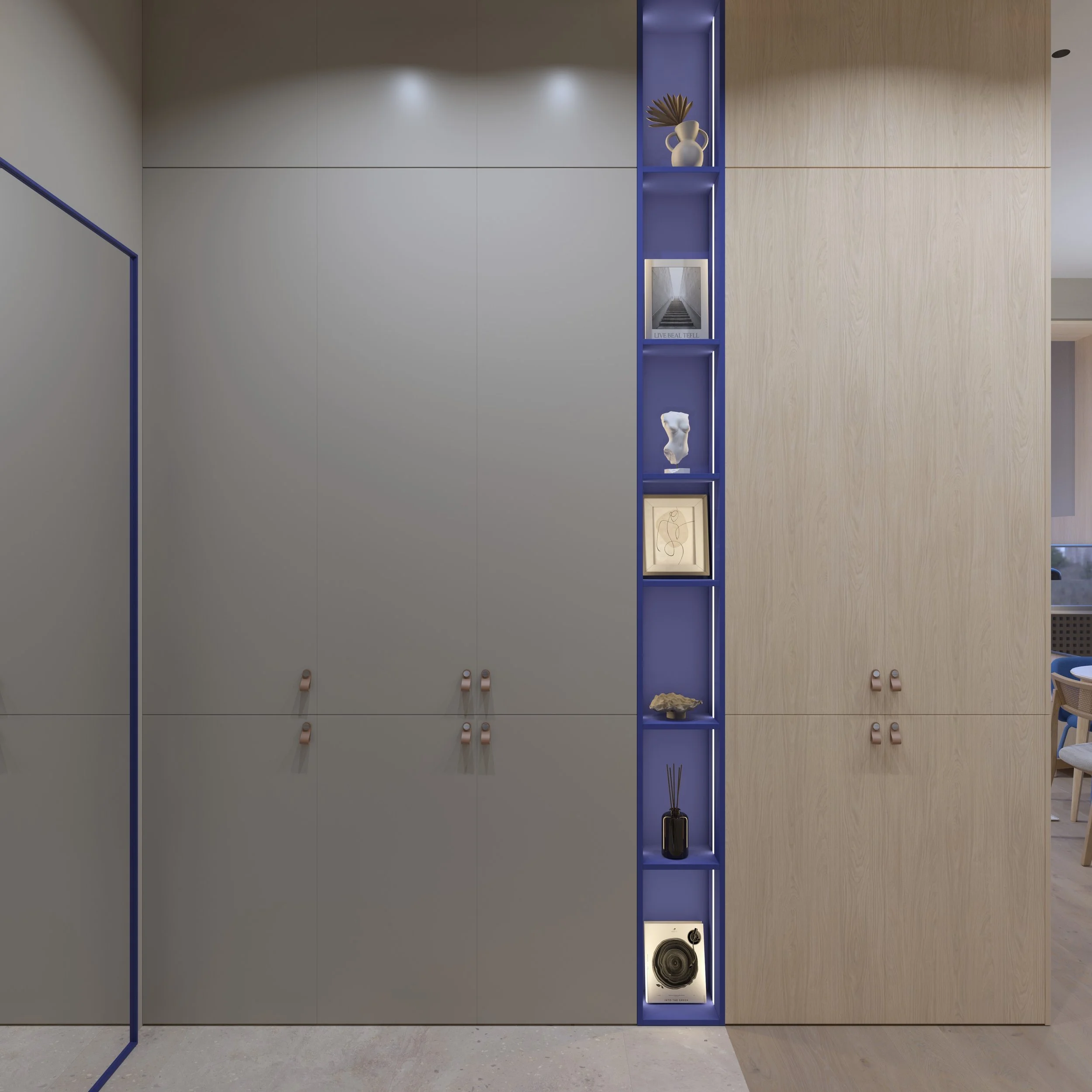 Cabinet with beige and blue sections, decorated with vases, artwork, and a speaker.