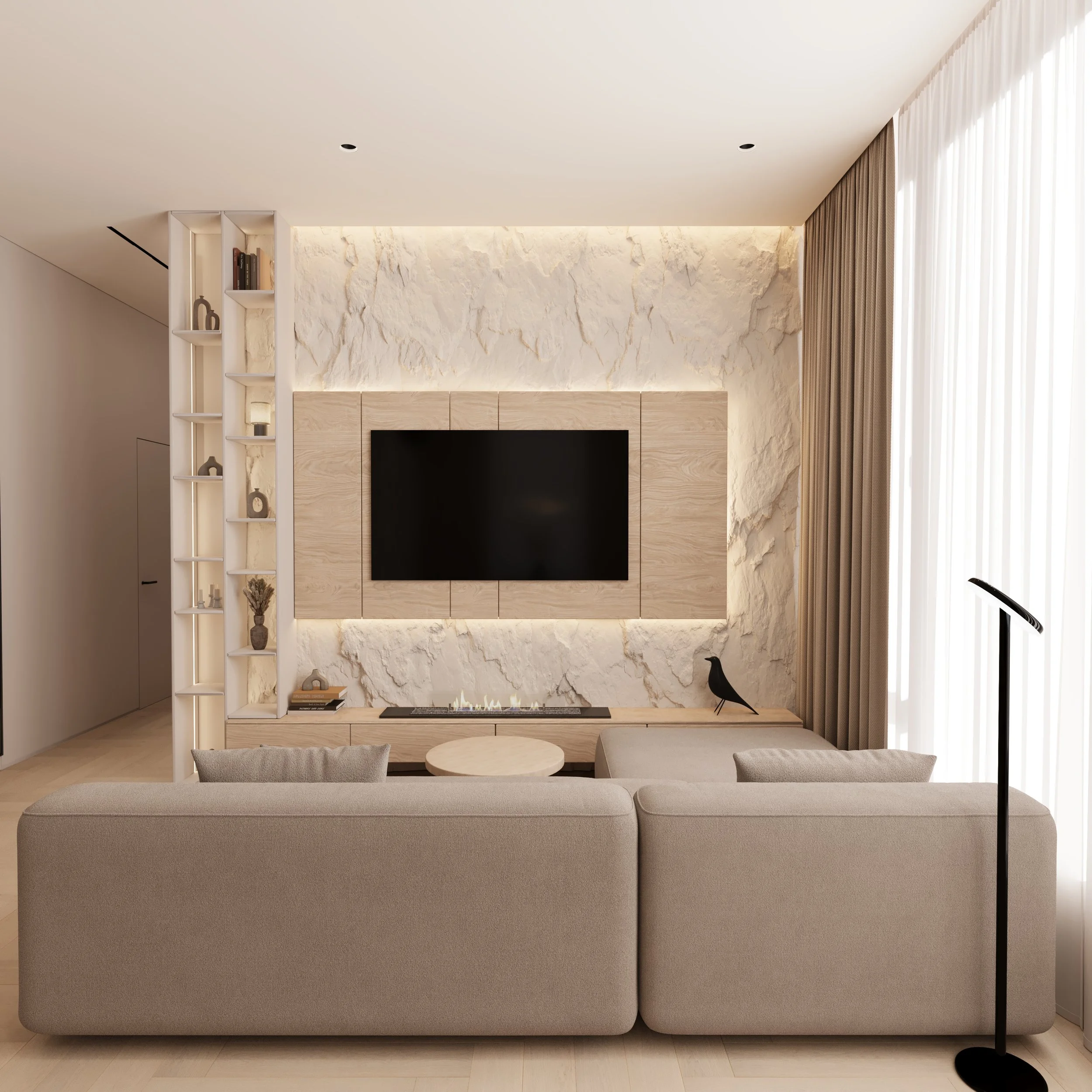 Living room with beige sofa facing a wall-mounted flat-screen TV, built-in shelves on the left, a minimalist gas fireplace, and cream-colored curtains.