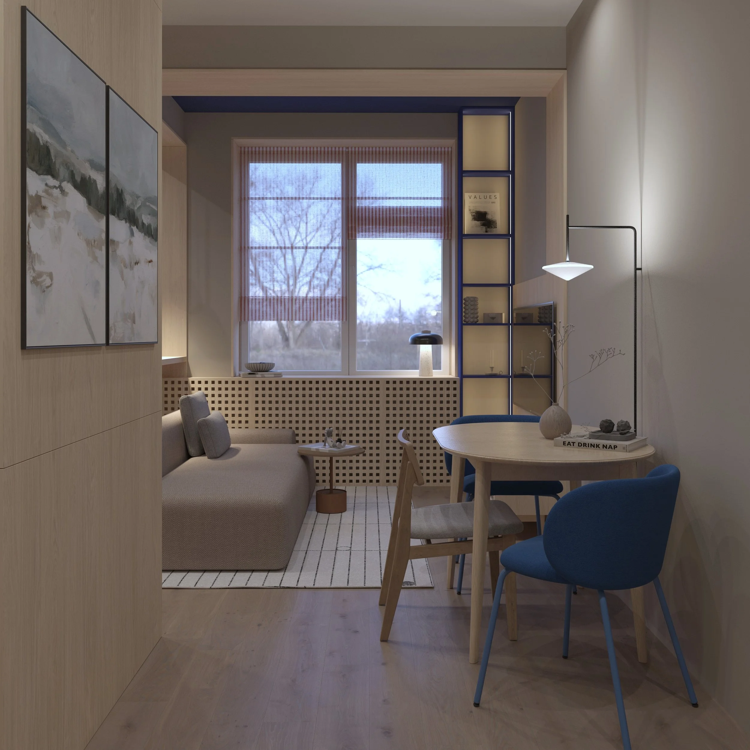 Cozy living room with a beige sofa, a small side table, a window with blinds, a blue shelving unit, a round dining table with blue and wooden chairs, and a standing lamp with a thin black stand. Decor includes wall art, vases, and books.