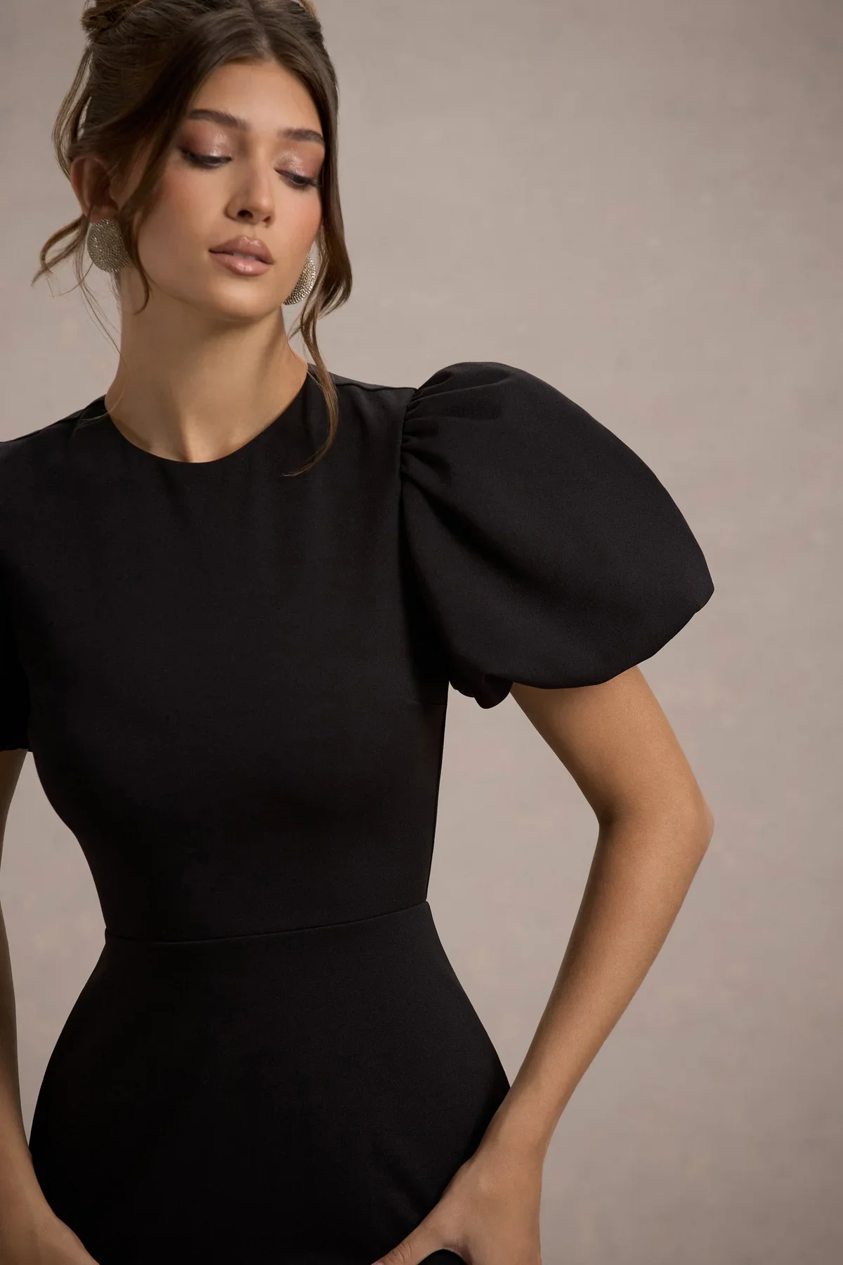 Woman in a black puff sleeve dress