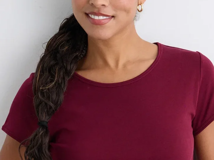 Woman in a red jewel neck shirt