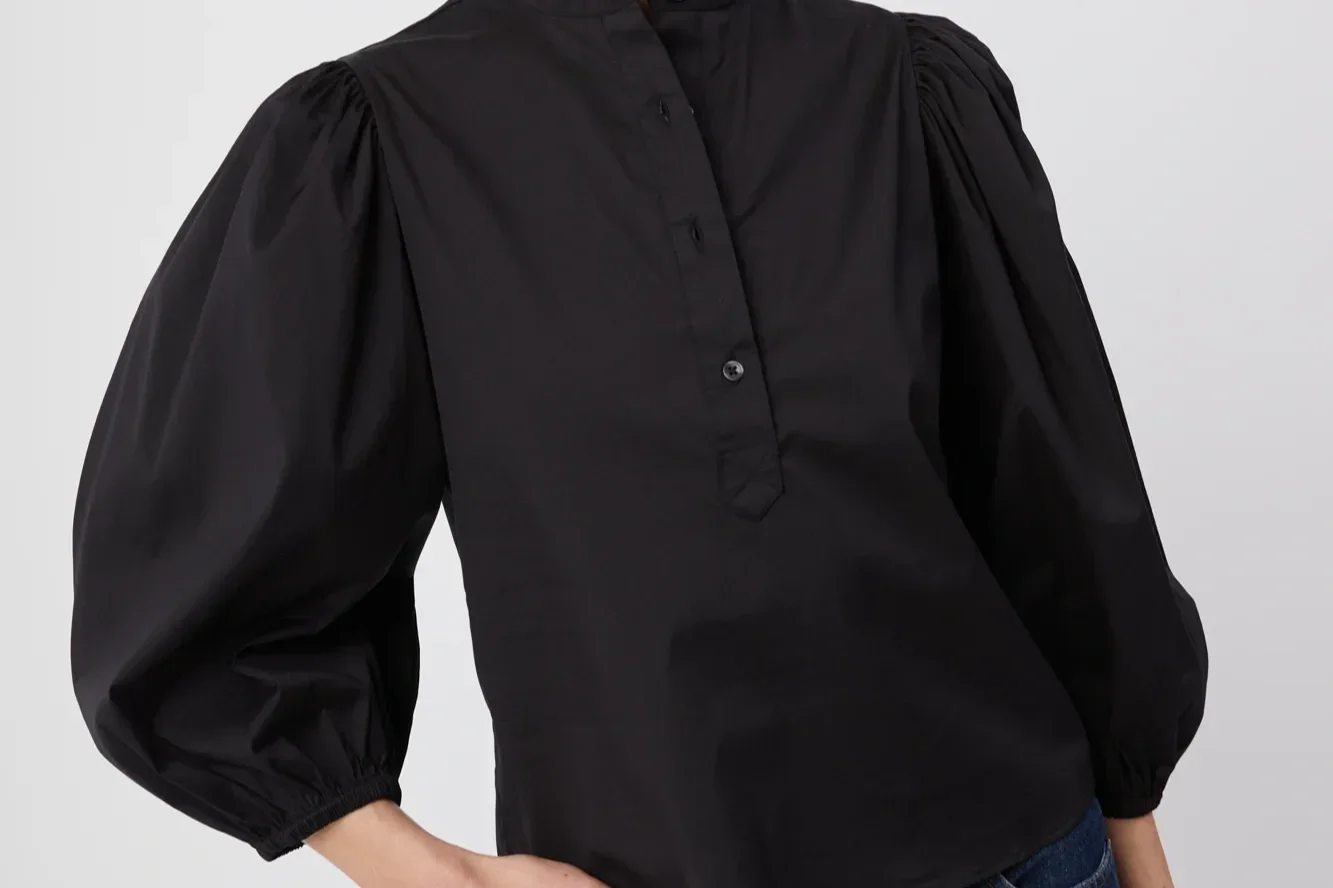 Woman in a black balloon sleeve top