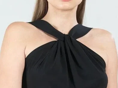 Woman in a black top with a Grecian neckline