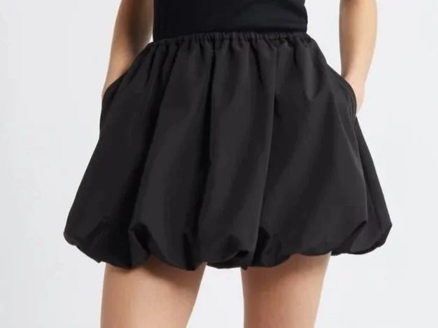 Woman in a black skirt with a puffy bubble hem