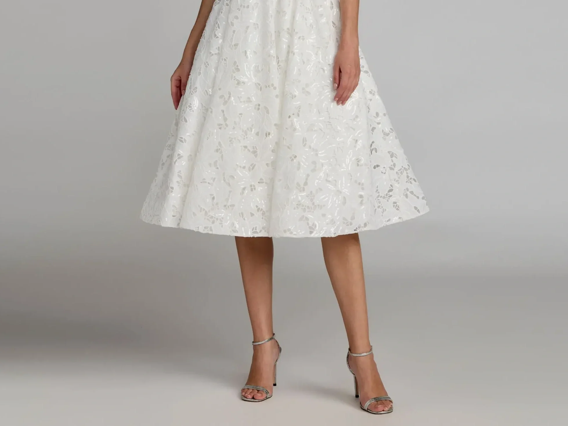 A white tea-length dress hitting just below the knees