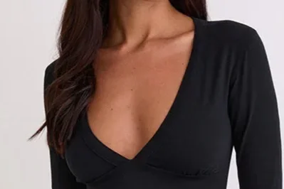 Woman in a black shirt with a plunging neckline