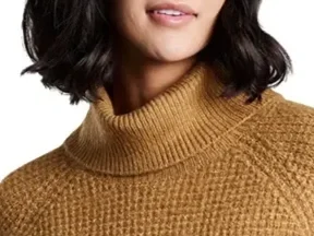 Woman in a tan cowl neck sweater