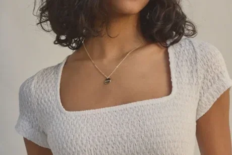 Woman in a white square neck shirt