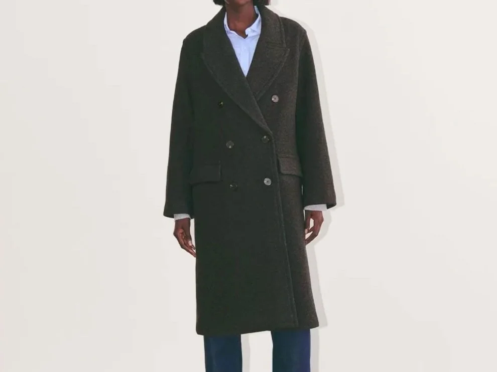 Woman in a buttoned black overcoat