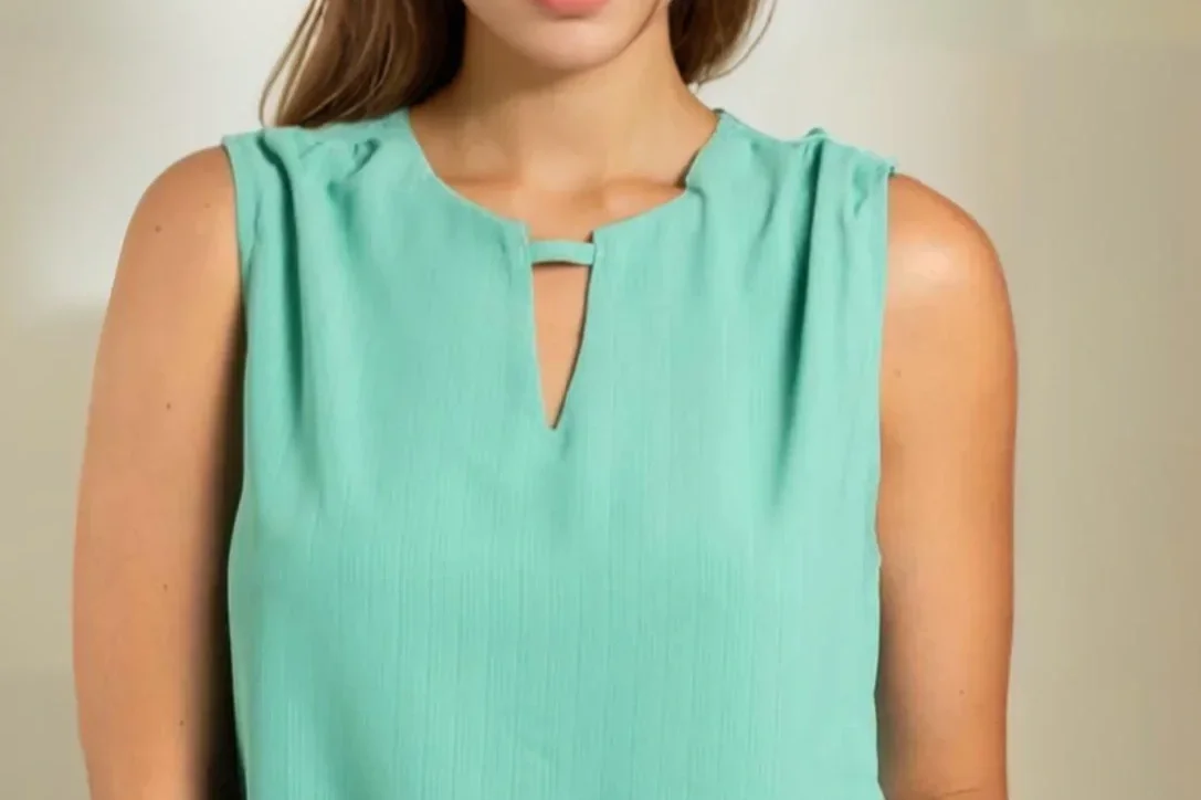 Woman in a teal keyhole neck blouse
