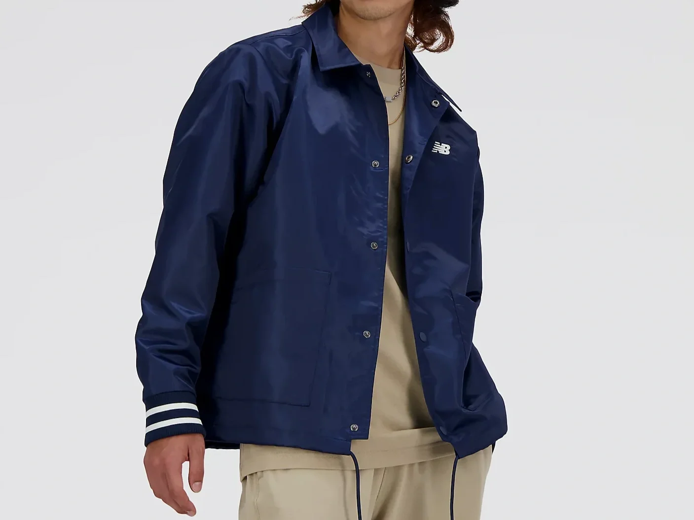 Man in a dark blue satin coach jacket