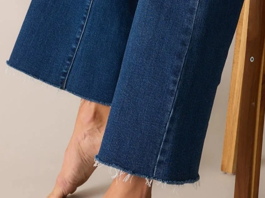 A pair of raw hem jeans