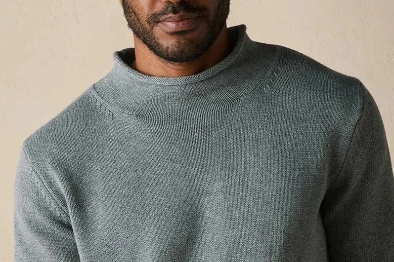 Man in a gray roll neck sweater