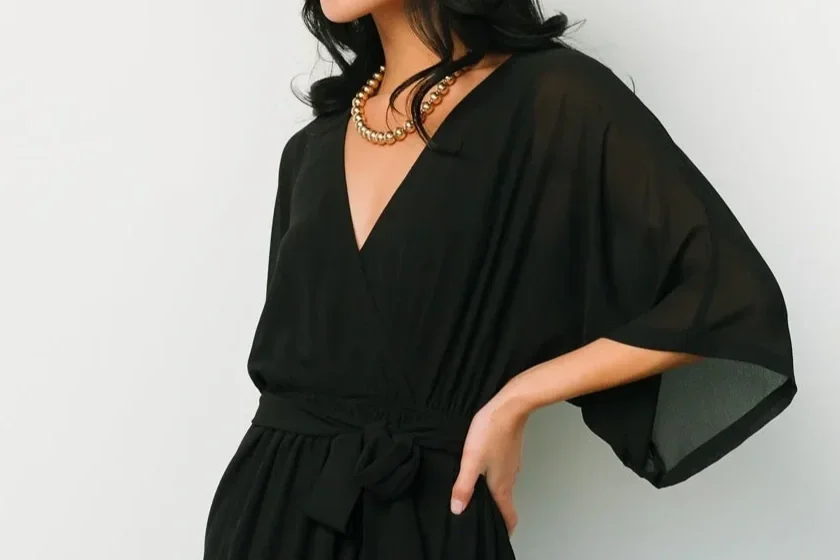 Woman in a black kimono sleeve dress