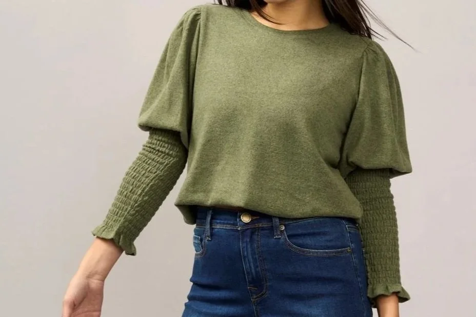 Woman in a green Juliet sleeve top