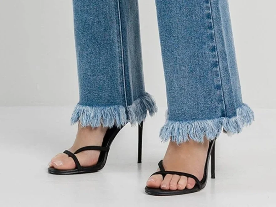 A pair of fringe hem jeans
