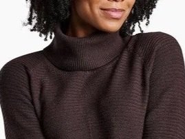 Woman in a brown funnel neck sweater