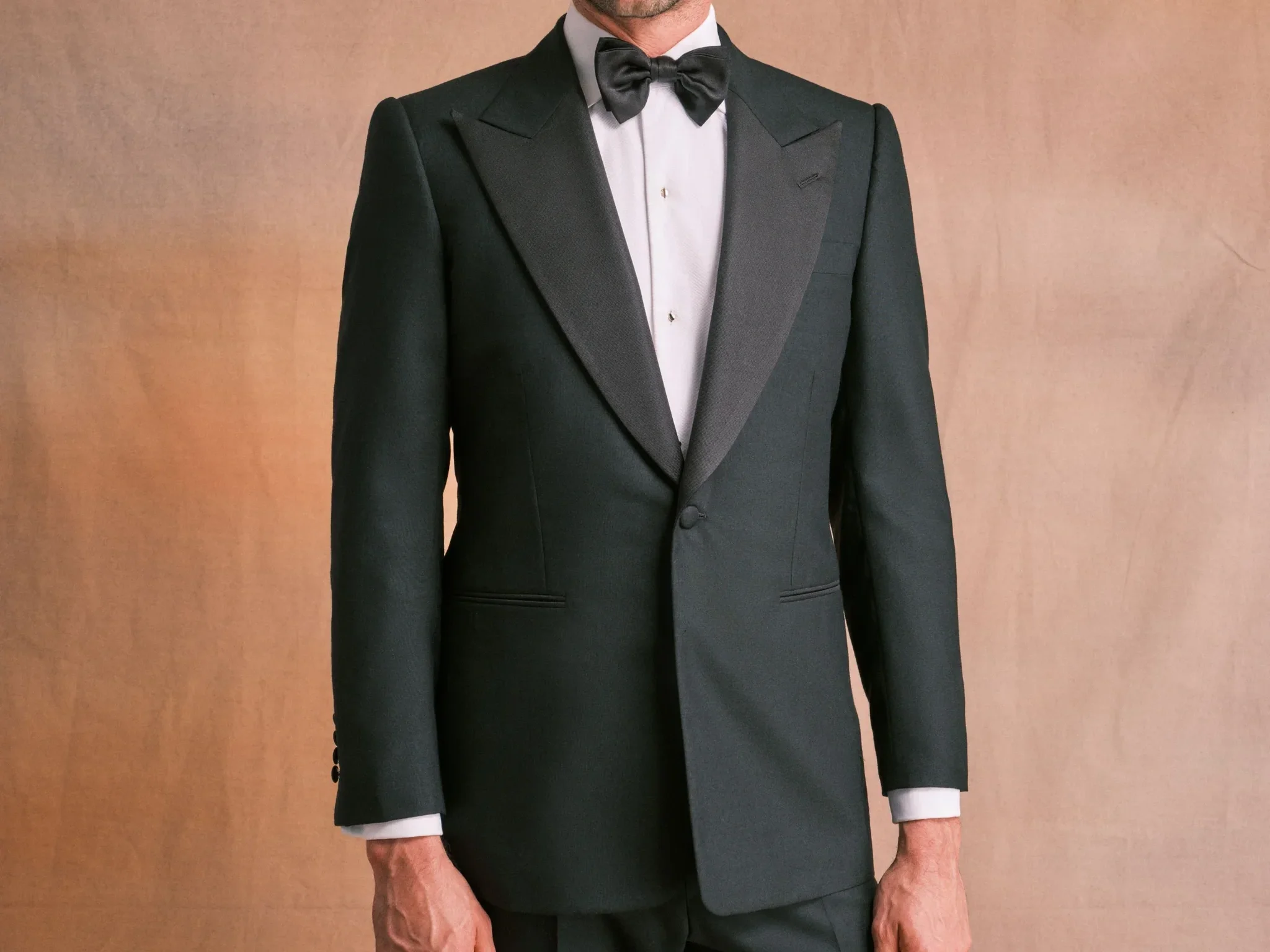 Man in a black dinner jacket, dress shirt, and bow tie