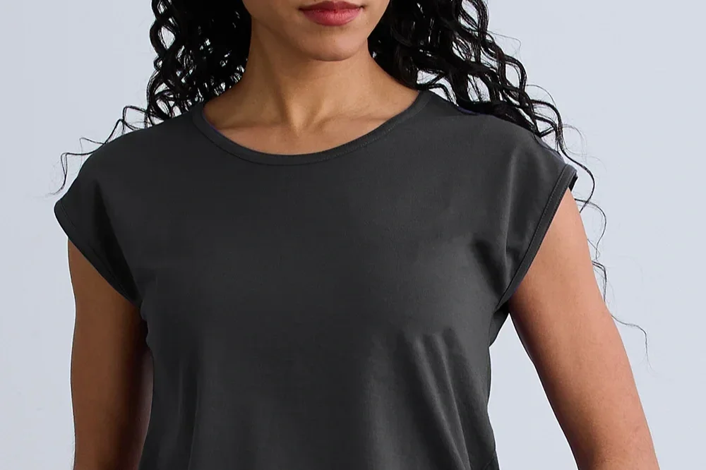 Woman in a gray cap sleeve shirt