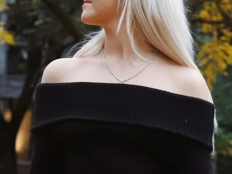 woman in a black bardot top