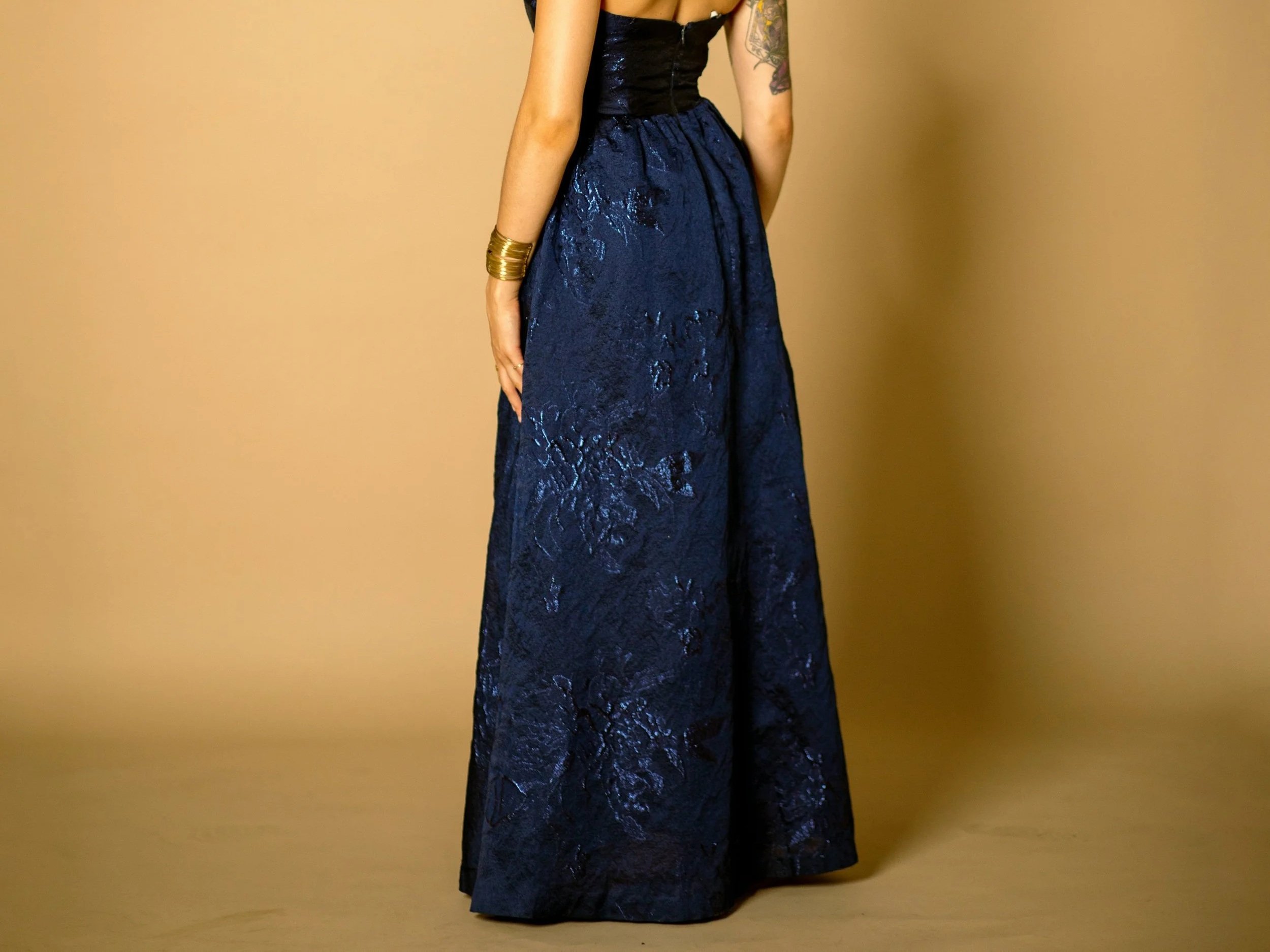 A woman in a blue floor length gown
