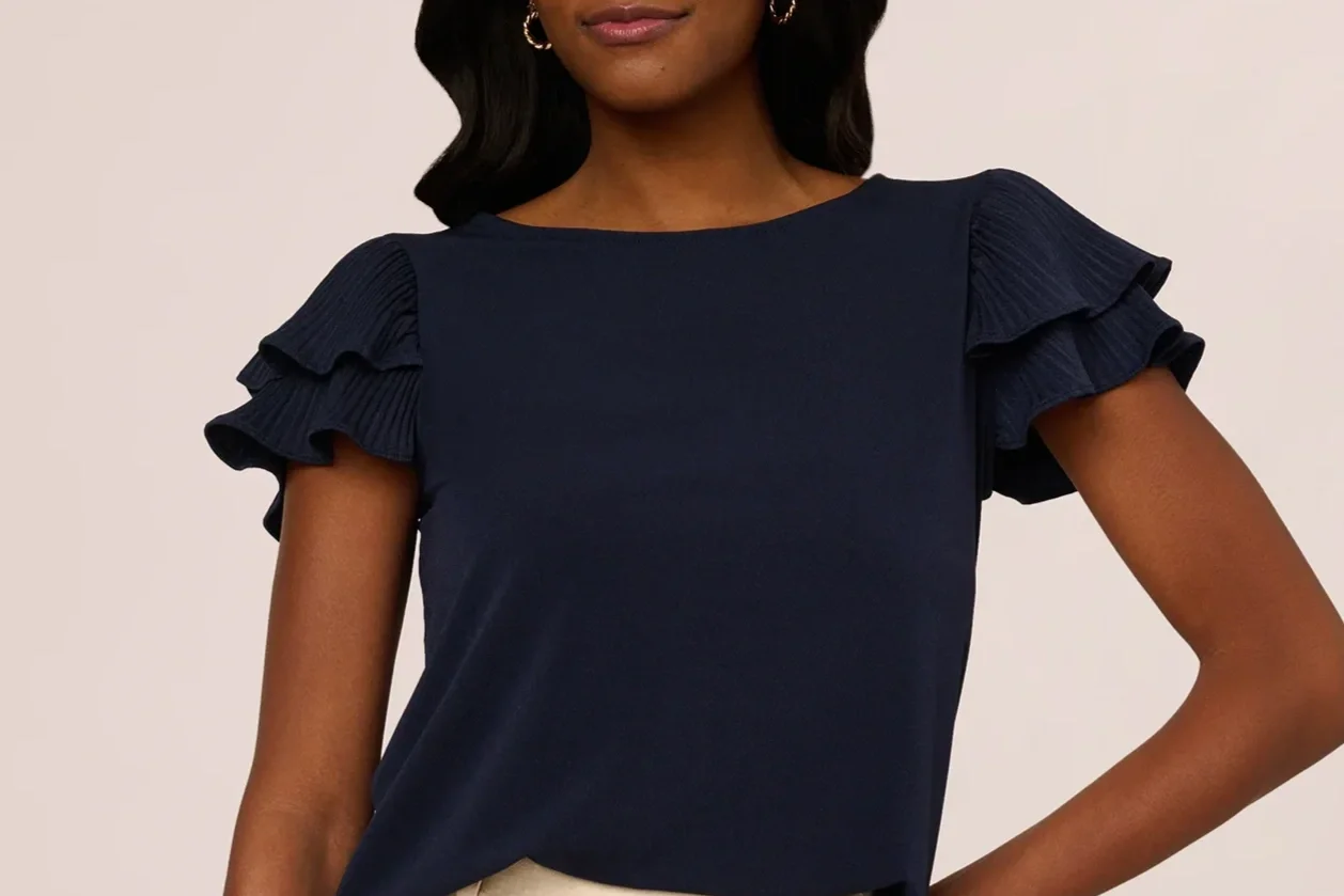 Woman in a black flutter sleeve shirt