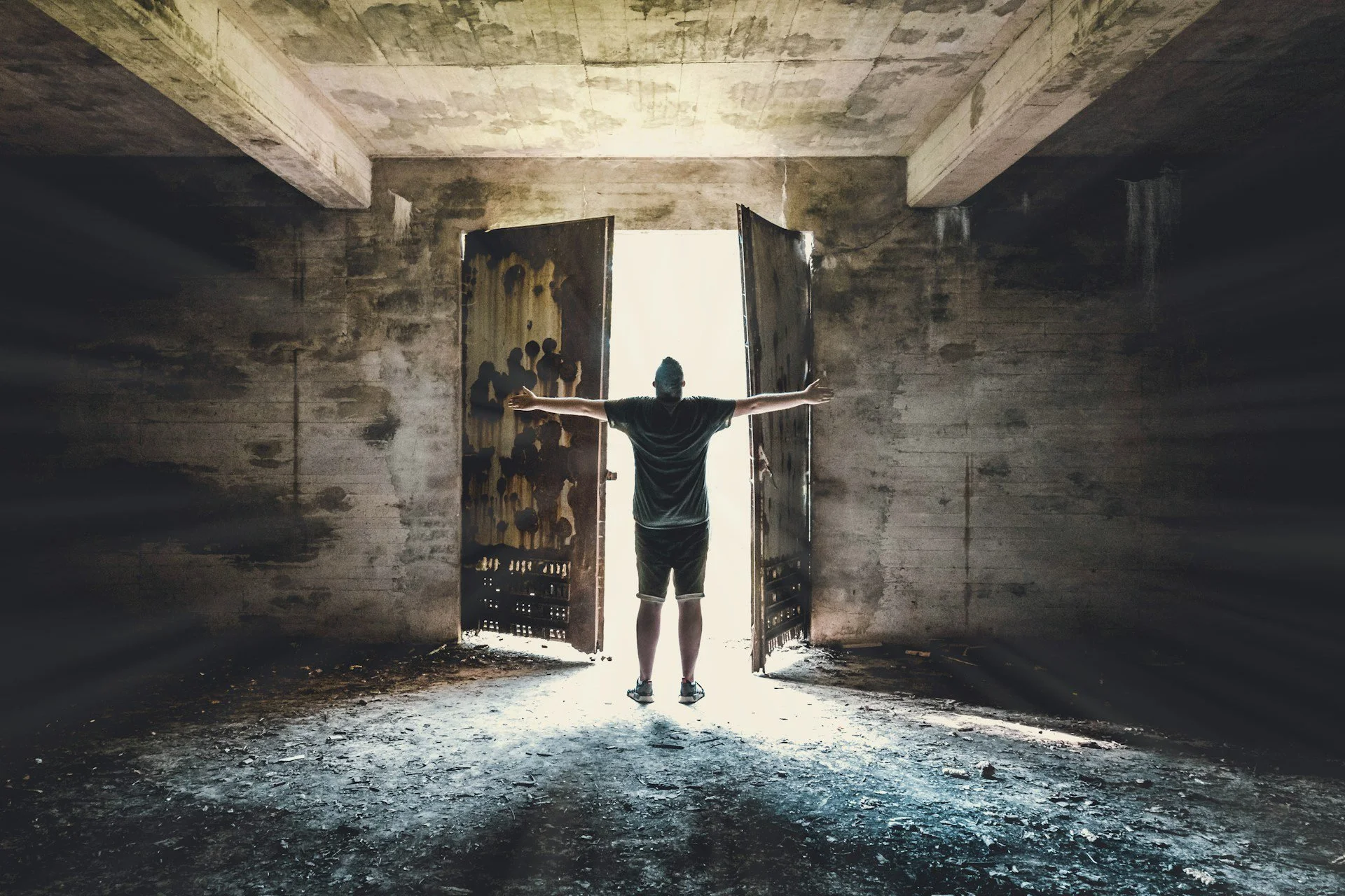 man opening a doors to let the light as a part of resisting temptation